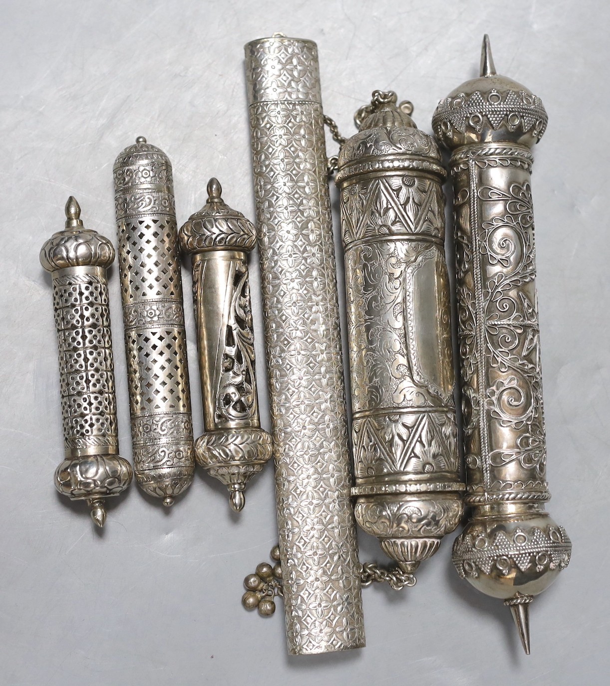 Six assorted 20th century Indian white metal scroll cases, including three pierced, largest 24.5cm.